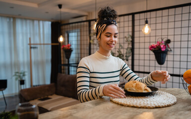 woman beautiful young female sit at the kitchen table have breakfast