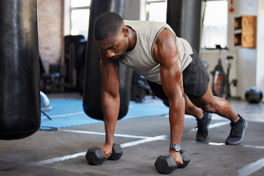 Weights, fitness and man training in the gym for muscle, body power and goals for health. Exercise, strength training and athlete doing bodybuilding workout for sports, cardio and weightloss