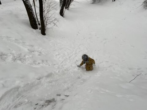 Girl is sliding down snowy hill. Vinter vacation