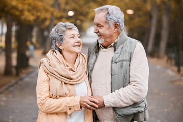 Senior couple, love and hug while walking outdoor for exercise, happiness and care at a park in nature for wellness. Old man and woman together in a healthy marriage during retirement with freedom