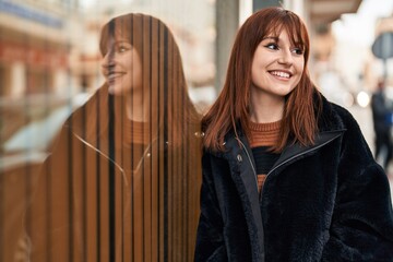 Young woman smiling confident standing at street