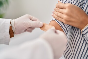 Man and woman doctor and patient having medical consultation vaccinating at clinic