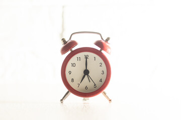 Red alarm clock set at four isolated over white background close-up with clipping path