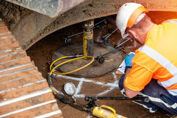 Builder performing ground bearing capacities test on building site