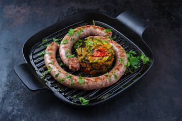 Traditional fried Italian salsiccia fresco meat sausage served with vegetable tartar and coriander...