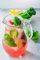 Strawberry basil lemonade iced jug pitcher over grey backdrop