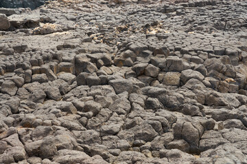 A stone volcanic backdrop on the coast of the island of Sal in Cape Verde.