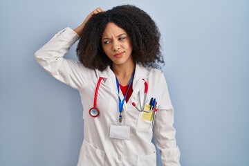 Young african american woman wearing doctor uniform and stethoscope confuse and wondering about...
