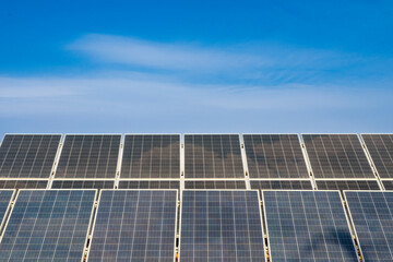 Photovoltaic solar power panel solar electric panels as uniform generator of energy industrial object against blue sky