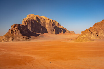 Fototapeta na wymiar Beautiful desert surrounded mountains in Wadi Rum, Jordan