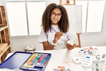 Fototapeta premium African american girl smiling confident drawing sculpture at art school