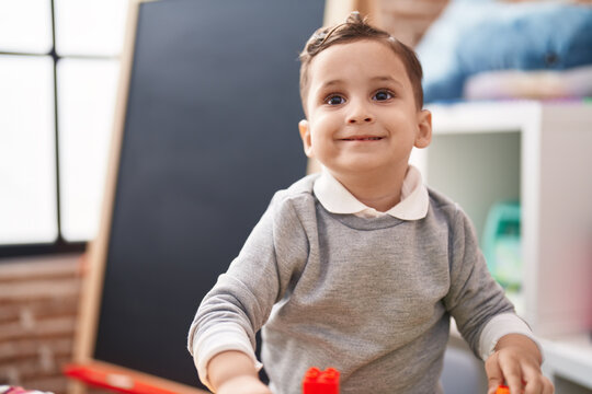 Adorable hispanic toddler smiling confident standing at kindergarten