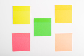 Five self-adhesive multi-colored stickers reminder mockup on a white surface
