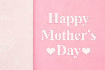Happy Mothers Day greeting on pink with ribbon
