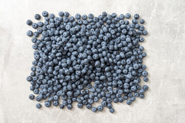 Top view of a group of fresh blueberries on gray background.