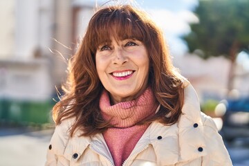 Middle age woman smiling confident standing at street