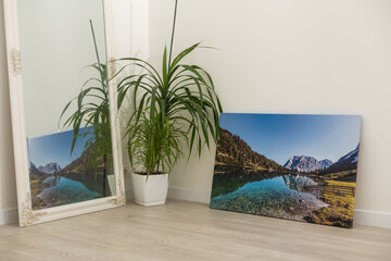 Canvas photo print on wooden floor. Sample of gallery wrapping method of canvas stretching on stretcher bar. Corner and edge of colorful photography closeup