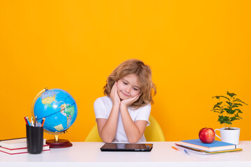 Smart caucasian school boy kid pupil student going back to school. Education kids. School boy isolated on yellow studio background.