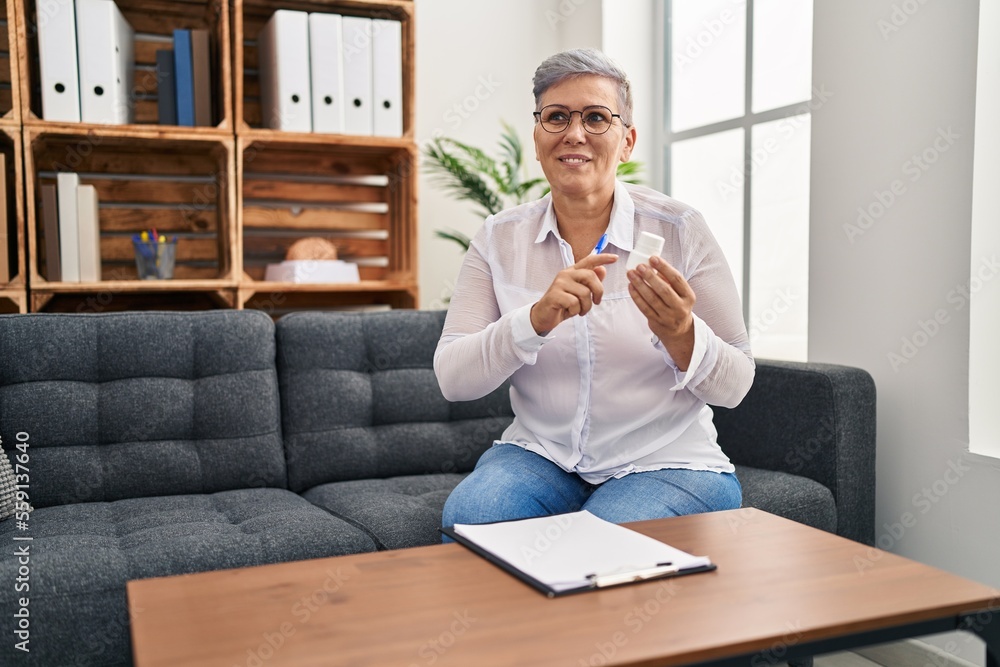 Wall mural middle age woman psychologist prescribe pills at pyschology center