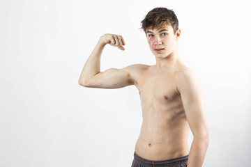 A shirtless 17 year old muscular boy