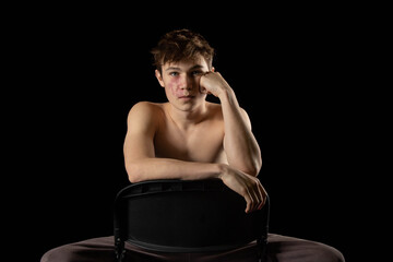 A shirtless 17 year old muscular boy