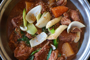 Pork spareribs seasoned and braised in a little broth with chili peppers, chestnuts, carrots and Korean dates