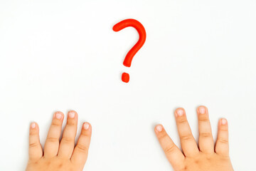 Baby hands and red question mark sign of plasticine on white background. FAQ and help concept.
