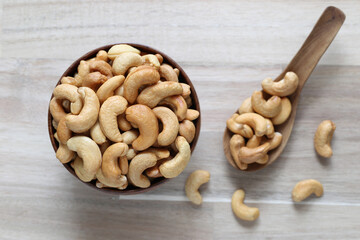 Top view of Roasted cashew nuts in a bowl on wooder background, Healthy eating concept