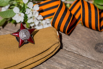 St. George's ribbon and the Order of the Red Star of the USSR World War II veteran on a wooden...