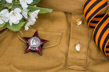 St. George's ribbon and the Order of the Red Star of the USSR World War II veteran on a wooden...