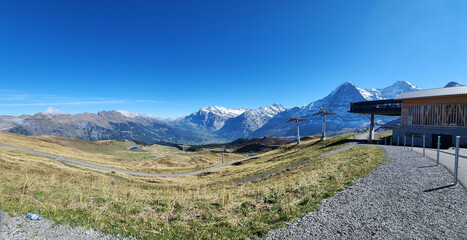 Panoramic view of snow mountain with rocky path and blue sky
