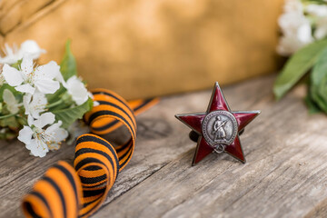 St. George's ribbon and the Order of the Red Star of the USSR World War II veteran on a wooden...