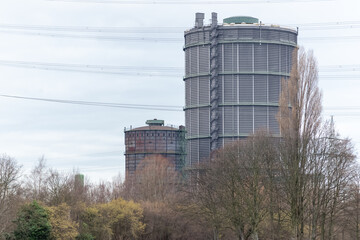 large gasometers in an industrial landscape