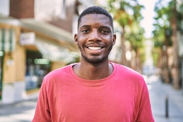 Young african man smiling confident at park