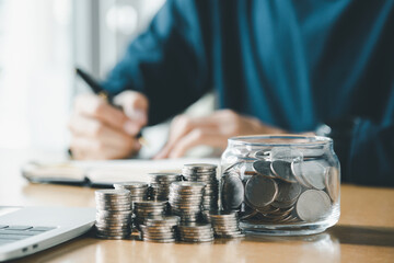 Man hands putting coins stack, Concept business finance saving money and investment.