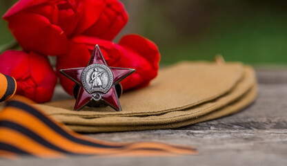 St. George's ribbon and the Order of the Red Star of the USSR World War II veteran on a wooden...