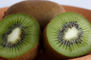 Closeup of whole and sliced kiwi fruit