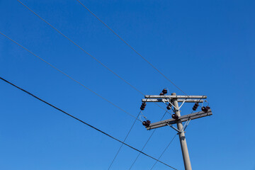Electricity transmission pole under blue sky. Countryside of Brazil