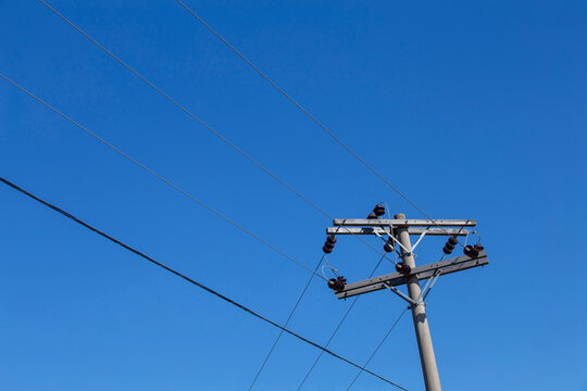Electricity transmission pole under blue sky. Countryside of Brazil