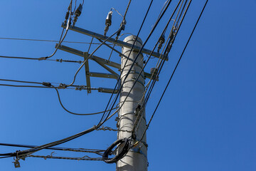 Closeup of electric power pole under blue sky on countryside of Brazil