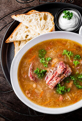 vegetables soup with meat in white bowl on table