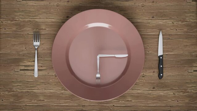 An empty dinner plate sitting on a wooden table with a knife and fork rotating on the plate like the hands of a clock - seamless looping.