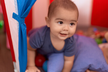 Adorable chinese toddler smiling confident sitting inside of circus tent at home