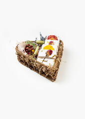 Natural homemade soaps with organic dried rose petals lies in a heart shaped basket. Corporate or personal gift idea. Gift for Women's Day, Valentine's Day, Mother's Day.