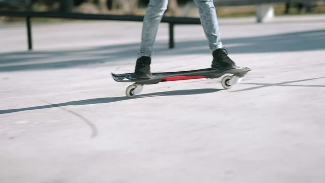 Legs on waveboard close up, Girl riding on casterboard with two wheels, modern street skate sports of teenagers, ripstick for balance ride.