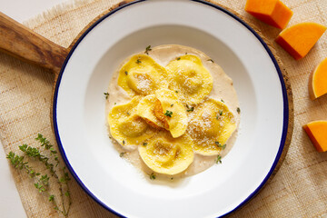 Panzerotti pasta stuffed with pumpkin cooked with sauce. Traditional Italian recipe.