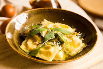 Stuffed ravioli pasta cooked with cheese sauce. Traditional Italian recipe.
