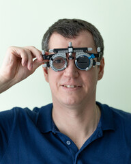 A man picks up glasses from an ophthalmologist in a medical office