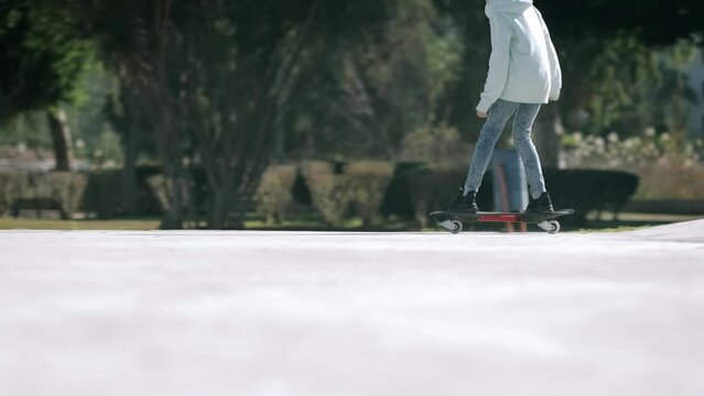Girl riding on waveboard with two wheels, modern street skate sports of teenagers, casterboard or ripstick for balance ride.