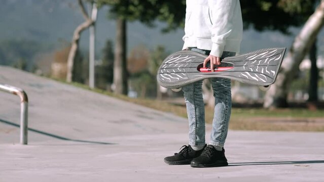 Girl riding on waveboard with two wheels, modern street skate sports of teenagers, casterboard or ripstick for balance ride.